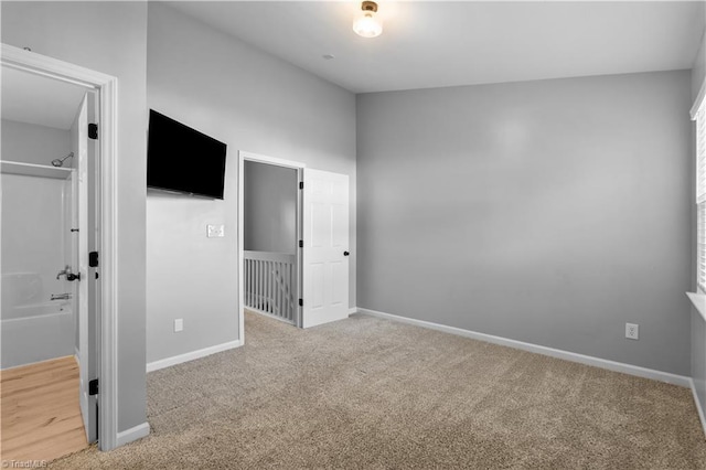 unfurnished bedroom featuring baseboards and carpet