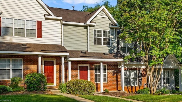 townhome / multi-family property with brick siding