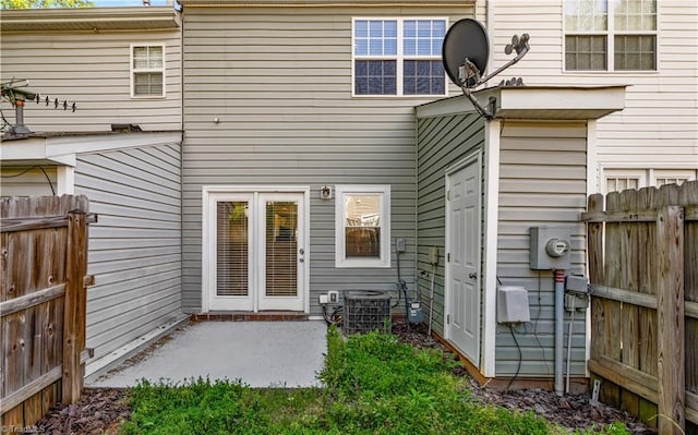 rear view of property featuring central air condition unit, fence, and a patio area