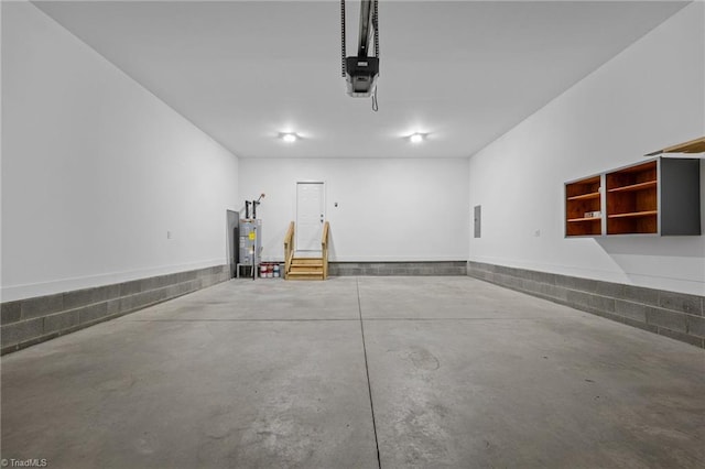 garage featuring water heater and a garage door opener