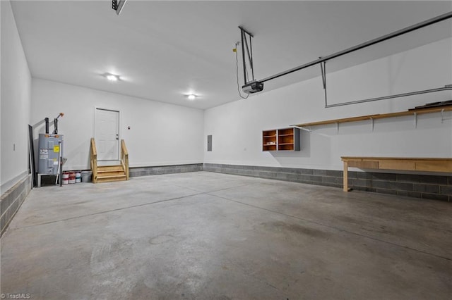 garage featuring electric water heater and a garage door opener