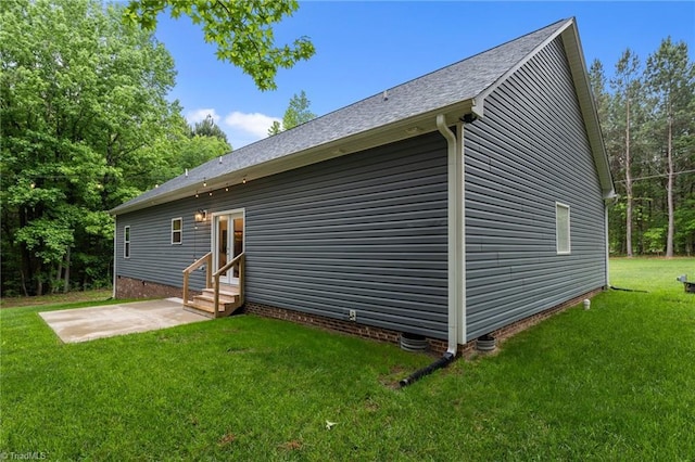 back of house featuring entry steps, a patio area, a yard, crawl space, and a shingled roof