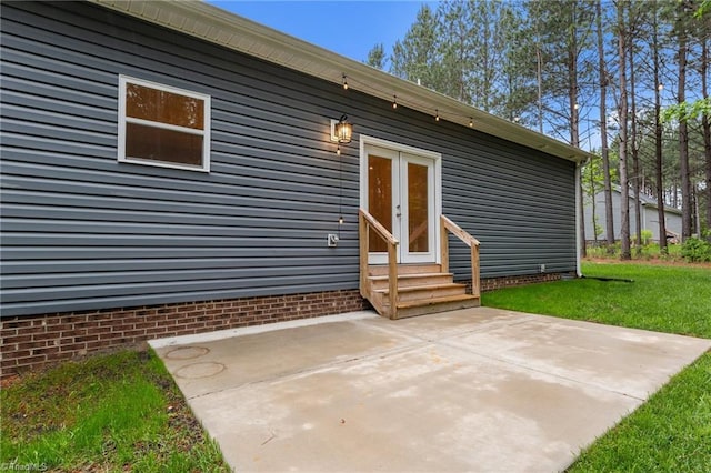 doorway to property featuring a patio area and a yard