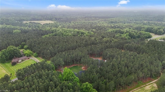 aerial overview of property's location with a heavily wooded area
