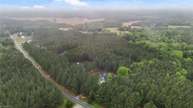 view of property location featuring a heavily wooded area