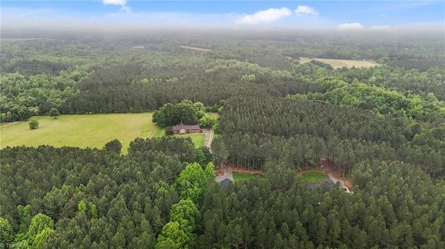 aerial view of property's location with a heavily wooded area