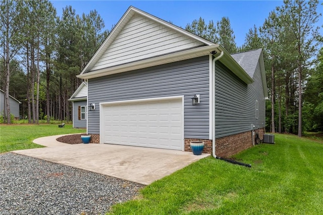 view of home's exterior with a garage, a lawn, central air condition unit, and driveway