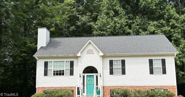 1020 Trevor Downs Ct, Lewisville, NC 27023 - split foyer home featuring a chimney and brick siding