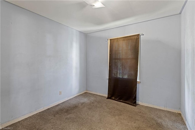 empty room with baseboards and carpet