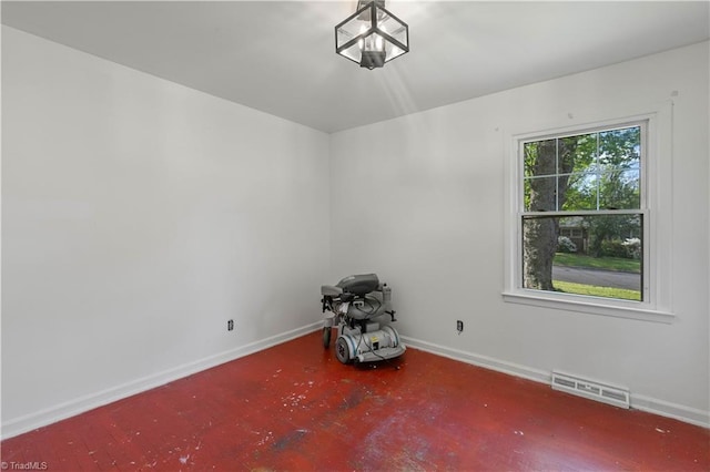 unfurnished room with baseboards and visible vents