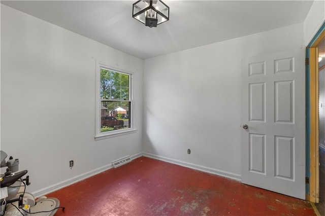 unfurnished room featuring baseboards and visible vents