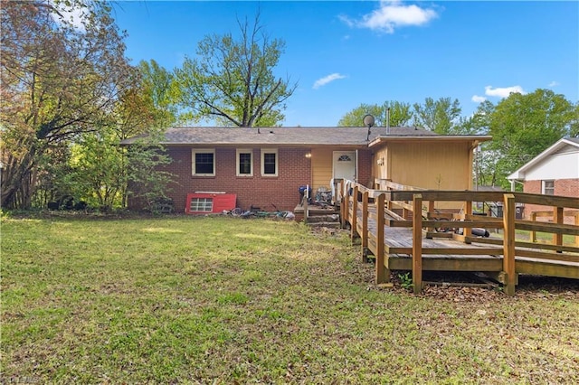 back of property featuring a lawn and a wooden deck