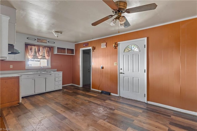 kitchen with light countertops, ceiling fan, dark wood finished floors, and extractor fan