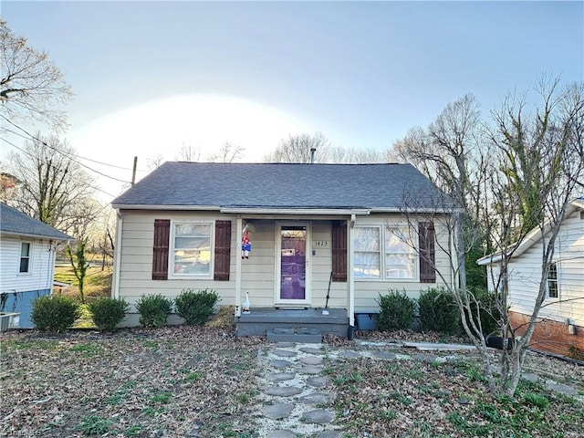 bungalow-style house featuring roof with shingles