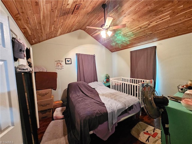 bedroom with wood finished floors, visible vents, lofted ceiling, ceiling fan, and wooden ceiling