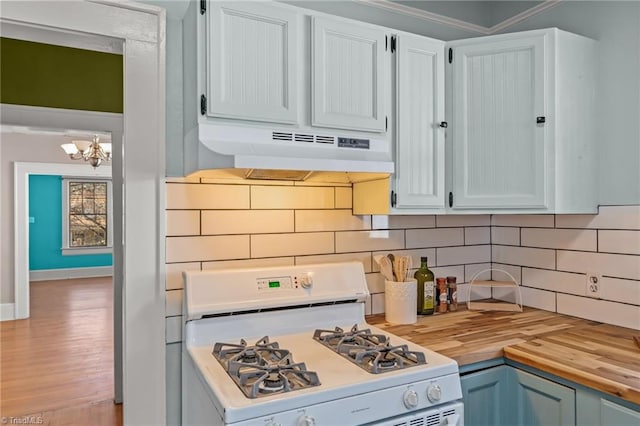 kitchen featuring white cabinets, white gas stove, wood counters, and tasteful backsplash