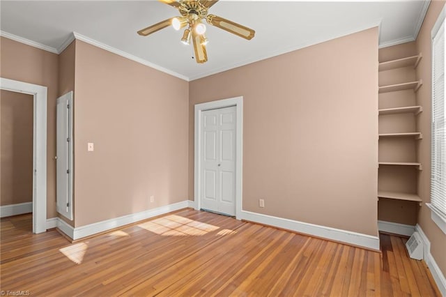 unfurnished bedroom with crown molding, hardwood / wood-style flooring, and ceiling fan