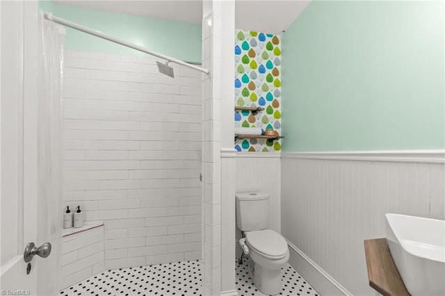 bathroom with toilet, a shower with curtain, and wooden walls