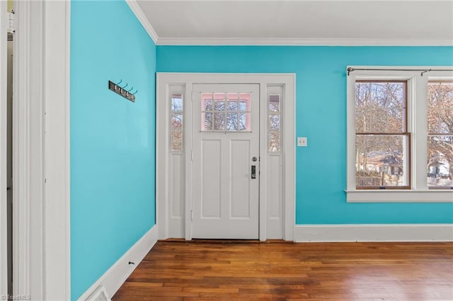 entryway featuring ornamental molding and dark hardwood / wood-style floors