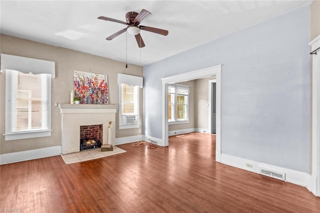 524 Horah St, Salisbury, NC 28144 - unfurnished living room with wood finished floors, ceiling fan, a fireplace, and cooling unit