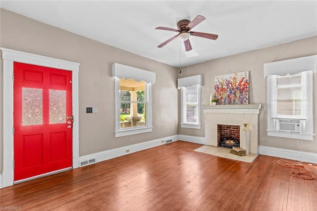524 Horah St, Salisbury, NC 28144 - unfurnished living room featuring wood finished floors, cooling unit, a fireplace, and ceiling fan