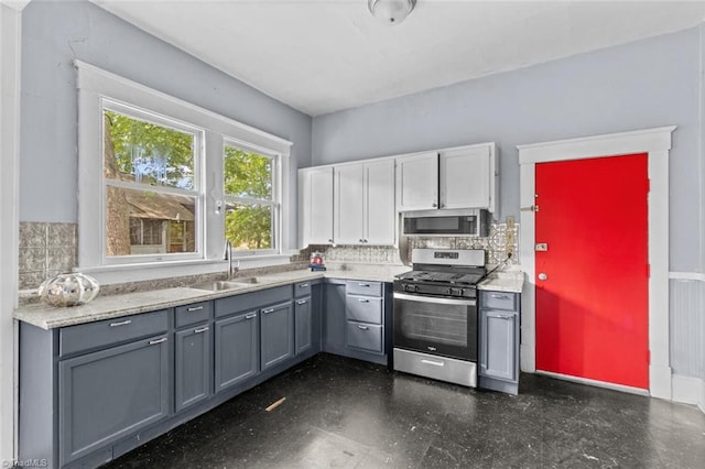 524 Horah St, Salisbury, NC 28144 - kitchen featuring stainless steel appliances, gray cabinetry, decorative backsplash, and light countertops
