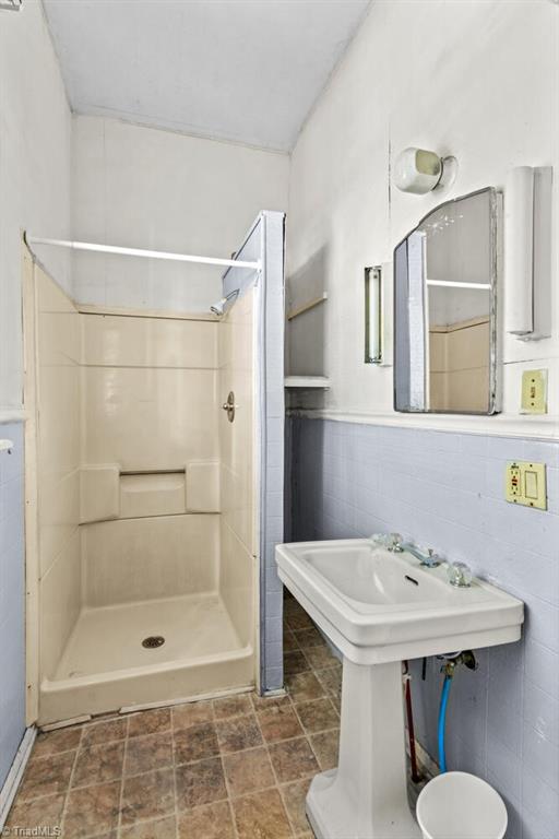 524 Horah St, Salisbury, NC 28144 - bathroom featuring a shower stall and a wainscoted wall