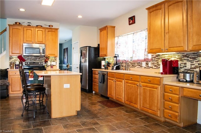 3029 Zacharys Keep Ct, Winston-Salem, NC 27103 - kitchen featuring appliances with stainless steel finishes, a kitchen island, decorative backsplash, light countertops, and recessed lighting