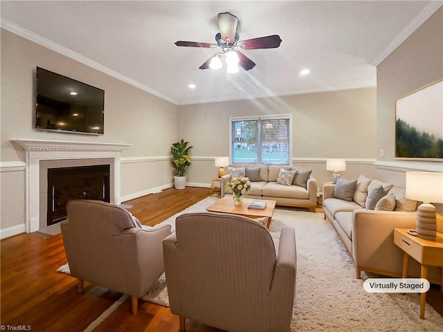 living room with crown molding, hardwood / wood-style flooring, and ceiling fan