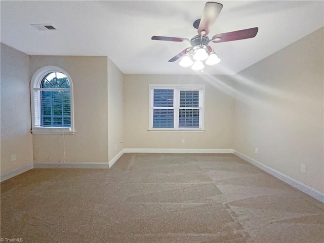 unfurnished room featuring lofted ceiling, light colored carpet, and ceiling fan