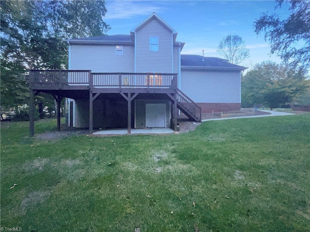 rear view of property featuring a wooden deck and a yard