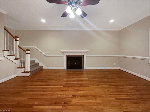 unfurnished living room with crown molding, wood-type flooring, and ceiling fan