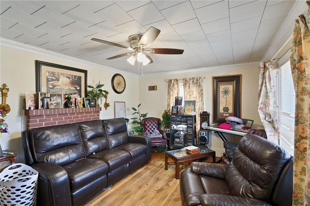 living room with ceiling fan, wood finished floors, and ornamental molding