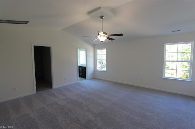 spare room featuring carpet flooring, ceiling fan, and vaulted ceiling