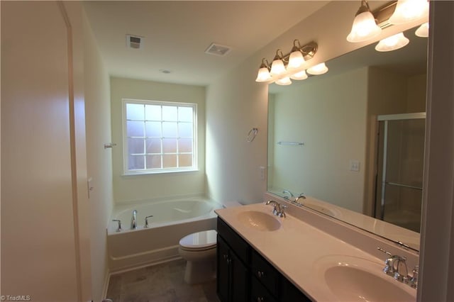 bathroom with toilet, a bath, and dual bowl vanity