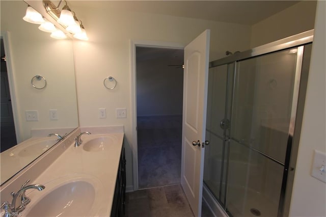 bathroom featuring an enclosed shower, double vanity, and tile patterned flooring