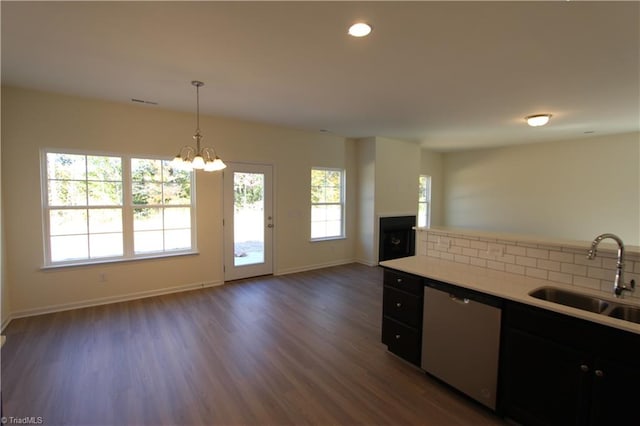 kitchen with a chandelier, stainless steel dishwasher, sink, dark hardwood / wood-style flooring, and hanging light fixtures