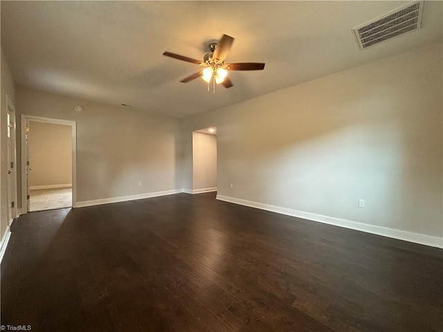 spare room featuring ceiling fan and dark hardwood / wood-style floors