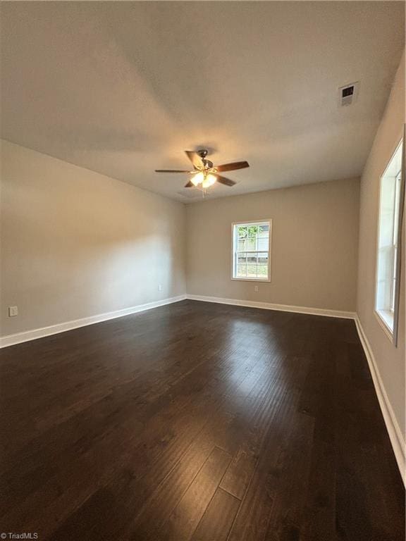 unfurnished room featuring ceiling fan and dark wood-type flooring