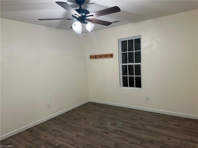 unfurnished room featuring a textured ceiling, ceiling fan, and dark wood-type flooring