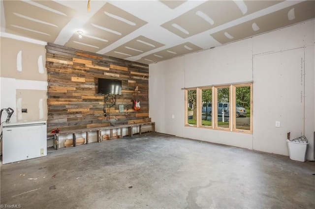 unfurnished living room with concrete flooring