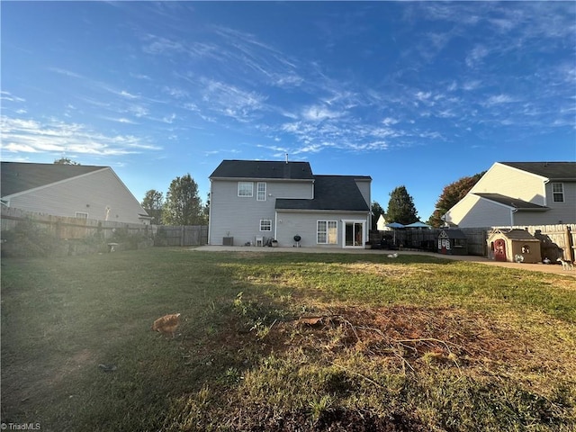 back of property featuring a yard and a patio area