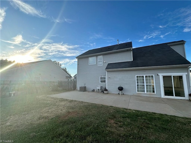 rear view of house with a yard, a patio area, and central air condition unit