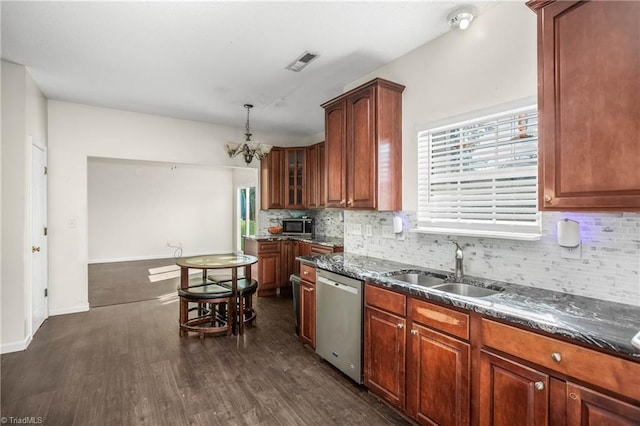 kitchen with sink, dark hardwood / wood-style flooring, stainless steel appliances, and a notable chandelier