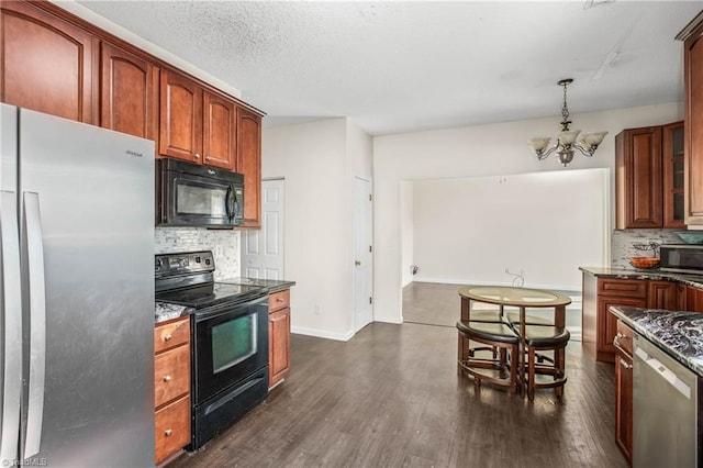 kitchen with backsplash, dark stone counters, dark wood-type flooring, black appliances, and an inviting chandelier