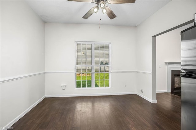 spare room with ceiling fan and dark hardwood / wood-style flooring