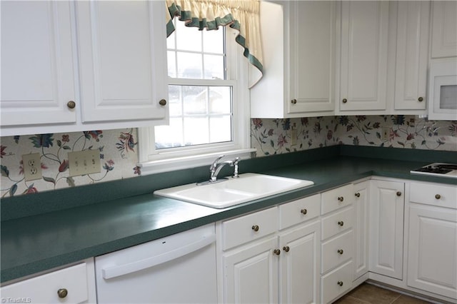 kitchen with white appliances, sink, and white cabinets