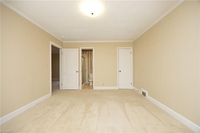 unfurnished bedroom with crown molding, light colored carpet, and connected bathroom