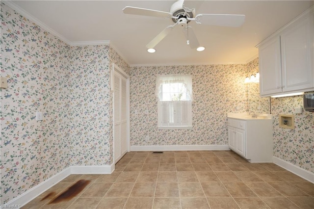 interior space featuring ceiling fan, ornamental molding, sink, and tile patterned flooring