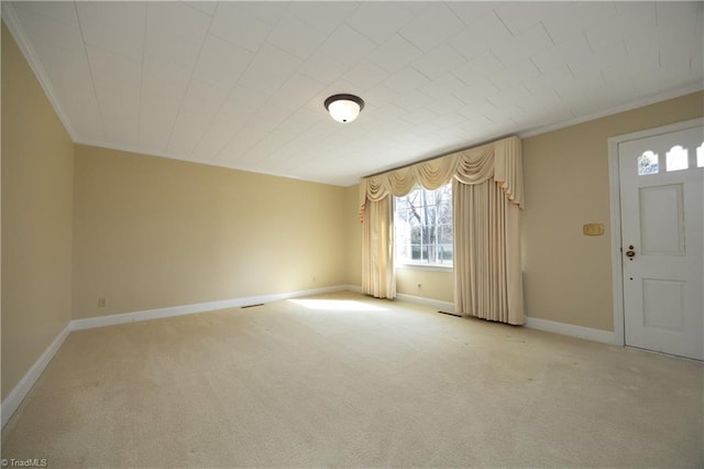 entrance foyer featuring ornamental molding and light carpet